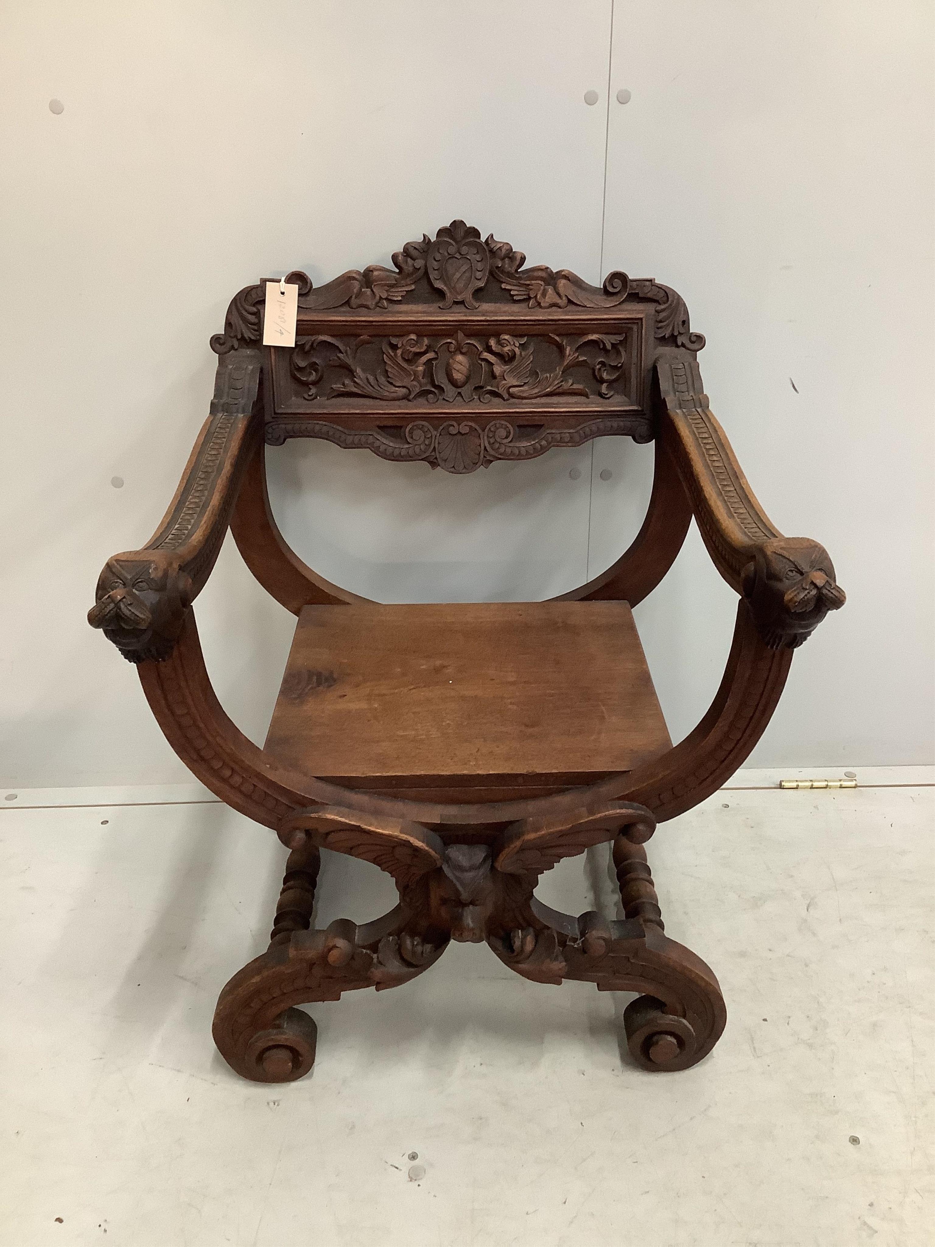 A carved 'X' framed chair, width 58cm, depth 53cm, height 79cm. Condition - fair